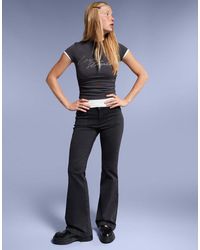 Bershka - Pantaloni A Zampa Neri Con Patta E Tasche - Lyst