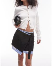 TOPSHOP - Minifalda negra cruzada con ribete en contraste y bordes sin rematar - Lyst