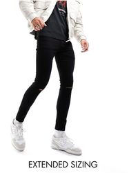 ASOS - Jeans super skinny ed elasticizzati neri con strappi sulle ginocchia - Lyst