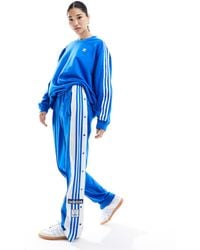 adidas Originals - Pantalones azul azulejo con botones - Lyst