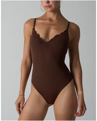 agon® - Lace Trim Bodysuit - Lyst