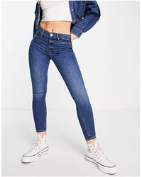 River Island - Molly - jeans skinny a vita medio alta modellanti sui glutei scuro - Lyst