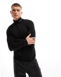 Tommy Hilfiger - Maglietta dolcevita nera a maniche lunghe con logo - Lyst