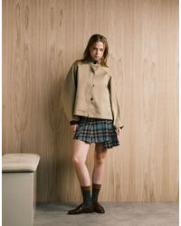 Monki - Mini-jupe plissée à carreaux et ourlet asymétrique - vert - Lyst