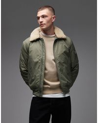 Schott Nyc - Veste matelassée courte zippée avec col en fausse fourrure et écusson à logo - sauge et beige - Lyst