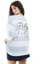 Monki - T-shirt oversize à imprimé style universitaire au dos et manches courtes - bleu et blanc à rayures - Lyst