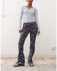 Monki - – bootcut-stretch-jeans mit em blumenmuster und niedrigem bund - Lyst