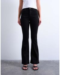 TOPSHOP - Vaqueros Negros De Talle Alto Y Corte Acampanado Jamie De - Lyst