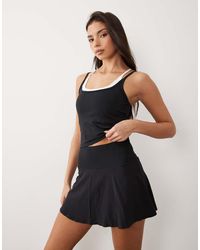 4505 - Falda Deportiva Negra De Estilo Tenista Con Vuelo Y Pantalones Cortos Integrados De Curve - Lyst