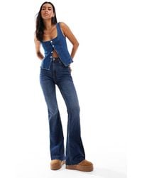 Stradivarius - Jeans A Zampa Con Spacco Sovratinto - Lyst