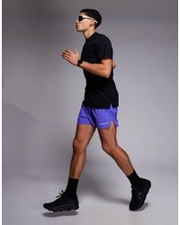 4505 - 3 Inch Quick Dry Split Running Shorts With Zip Pockets And Reflective Graphic - Lyst