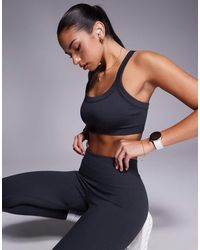 4505 - Reggiseno Sportivo A Supporto Medio Senza Cuciture Modellante Pietra Focaia Con Spalline Regolabili - Lyst