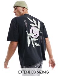 ASOS - Camiseta negra extragrande con estampado floral en la espalda - Lyst