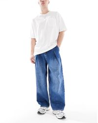 ASOS - Jeans A Fondo Super Ampio Lavaggio Medio Con Pieghe - Lyst