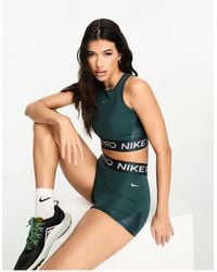 Nike - Nike - pro training - débardeur court en tissu dri-fit brillant - jungle - Lyst