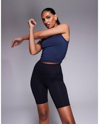 4505 - Leggings Cortos De 20 Cm Negros De Talle Alto De Tejido Suave De Secado Rápido Icon De - Lyst