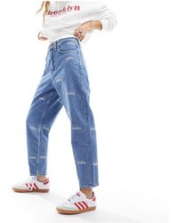 Tommy Hilfiger - Mom jeans affusolati a vita super alta lavaggio medio - Lyst