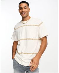 Levi's - T-shirt color crema a righe con tasca con logo - Lyst