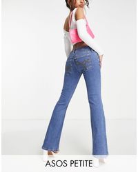 ASOS Asos design petite - jeans a zampa elasticizzati a vita bassa lavaggio medio - Blu
