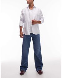 Wrangler - Jean bootcut ample - moyen délavé - Lyst