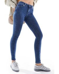 ONLY - – eng geschnittene jeans aus dunkelem denim mit push-up-effekt - Lyst