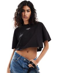 Tommy Hilfiger - T-shirt corta oversize nera con logo - Lyst