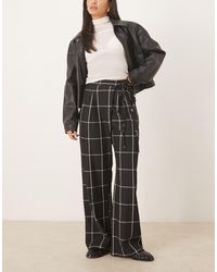 ASOS - Pantalon ample avec détail croisé noué sur le côté - noir et blanc à carreaux - Lyst
