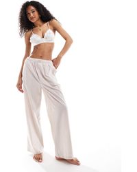Calvin Klein - – gestreifte lounge-hose aus baumwolle mit weitem bein und logo-bund - Lyst