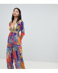 ASOS Asos Design Petite Chiffon Plunge Beach Jumpsuit In Tropical Tile Print - Multicolor