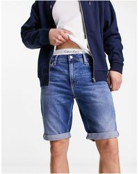 Calvin Klein - Cc - pantaloncini di jeans slim lavaggio medio - Lyst