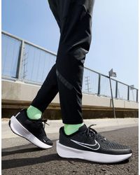 Nike - Interact - sneakers nere con dettagli bianchi - Lyst