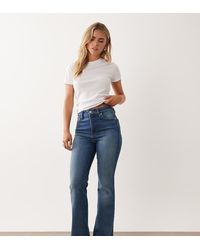 Good American Petite - Soft Tech Classic Bootcut Jeans - Lyst