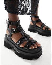 Koi Footwear - Sandalias negras con suela gruesa y púas he divine - Lyst