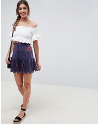 ASOS Minifalda con botones delanteros, detalles bordados y sobrefalda en el bajo - Azul
