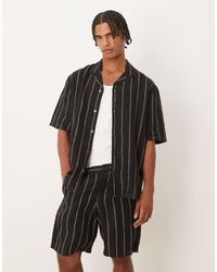Mango - Pantalones Cortos Negros A Rayas Blancas De Lino De - Lyst