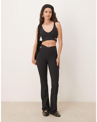 Nike - Pantalones De Campana Negros De Talle Alto Con Abertura De Canalé Dri-Fit Zenvy De - Lyst