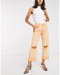 ASOS Jeans carpenter a vita molto bassa con strappi evidenti arancioni - Arancione