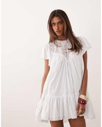 Noughts & Kisses - Crochet Insert Flutter Sleeve Dropped Hem Mini Dress - Lyst