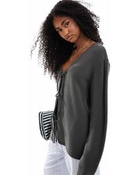 ASOS - Gilet oversize en maille avec col v et liens noués à l'avant - olive - Lyst