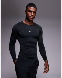 Nike - Nike - training pro - top moulant à manches longues en tissu dri-fit - Lyst