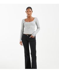 Only Petite - Lola Super Low Waist Flared Jeans - Lyst
