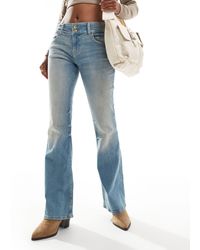 Bershka - Jeans bootcut a vita bassa lavaggio azzurro sporco - Lyst