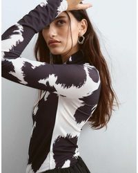 ARRANGE - Premium Mesh Top Met Lange Mouwen En Koeienprint - Lyst