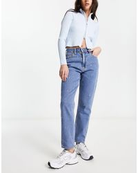 Hollister - Mom jeans a vita alta con strappi sulle ginocchia e decorazioni lavaggio medio - Lyst