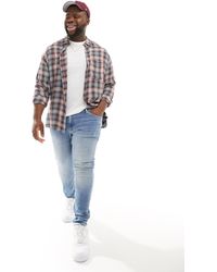 Calvin Klein - Plus – eng geschnittene denim-jeans - Lyst