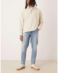 ASOS - Vaqueros De Corte Tapered Elástico Con Lavado Azul Medio De - Lyst