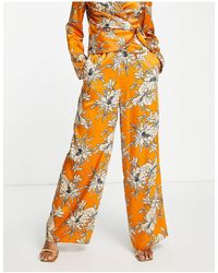 ASOS - Pantalon large d'ensemble en satin à imprimé fleurs - orange - Lyst