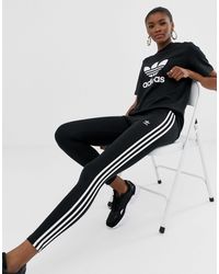 adidas originals adicolor three stripe stirrup jumpsuit in black