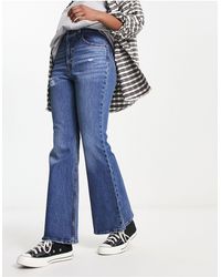 Levi's - Jeans a vita alta a zampa invecchiati lavaggio medio stile anni '70 - Lyst