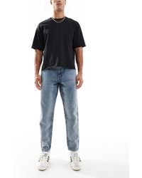 ASOS - Jeans Affusolati Lavaggio Medio Con Tinta Vintage - Lyst